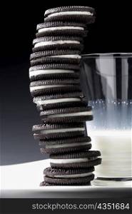 Close-up of a glass of milk with stack of cookies