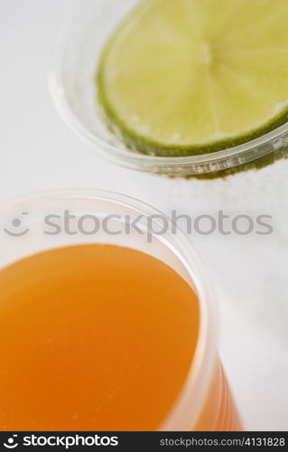 Close-up of a glass of orange juice and a glass of lemonade