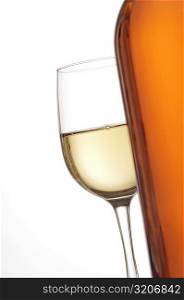 Close-up of a glass of wine with a wine bottle