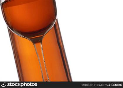 Close-up of a glass of wine with a wine bottle