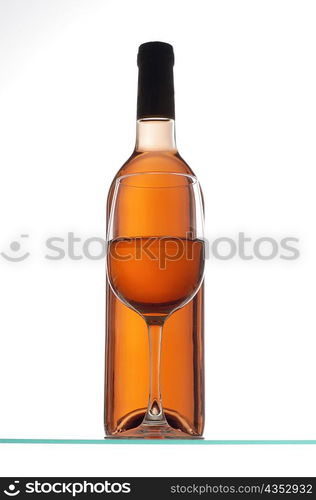 Close-up of a glass of wine with a wine bottle