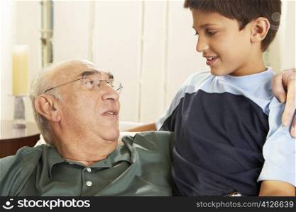 Close-up of a grandfather talking to his grandson