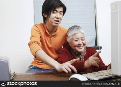 Close-up of a grandmother and her grandson using a computer