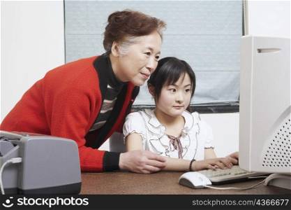 Close-up of a grandmother standing beside her granddaughter