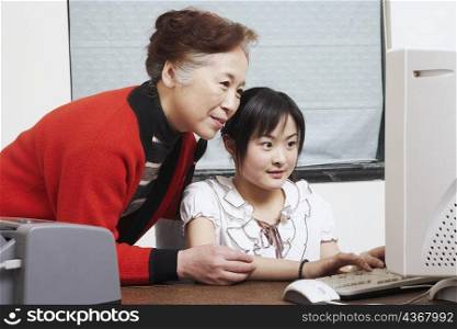Close-up of a grandmother standing beside her granddaughter