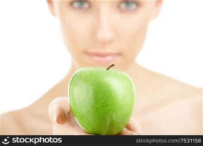 Close up of a green apple against a woman&rsquo;s face, isolated
