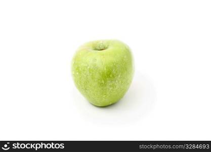 close up of a green apple on a white background