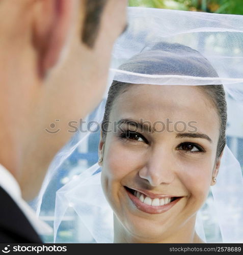 Close-up of a groom lifting his bride&acute;s veil