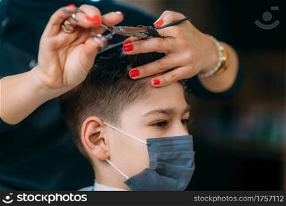 Close-up of a hairdresser&rsquo;s hands cutting hair in hair salon. Hair Salon, Child Hair Cutting