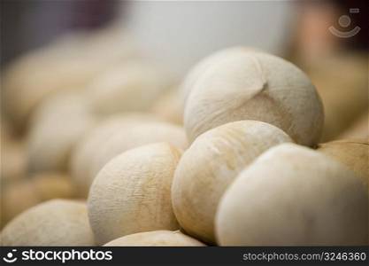 Close-up of a heap of coconuts at a market stall
