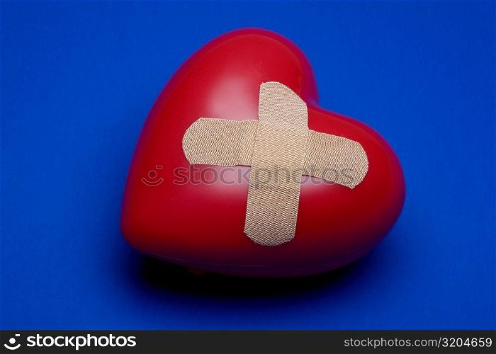 Close-up of a heart with a bandage on it