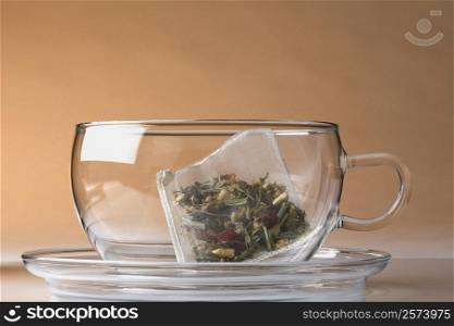 Close-up of a herbal teabag in a cup