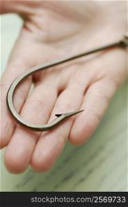 Close-up of a hook on a human palm