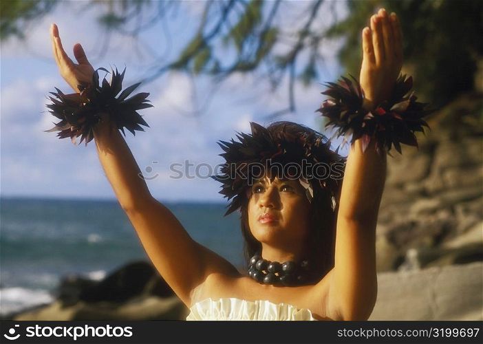 Close-up of a hula dancer with her arms raised, Hawaii, USA