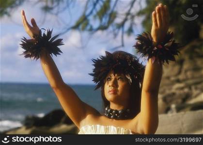 Close-up of a hula dancer with her arms raised, Hawaii, USA