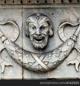 Close-up of a human face carved on a wall, Bergen, Norway