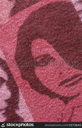 Close-up of a human face knitted on a woolen fabric