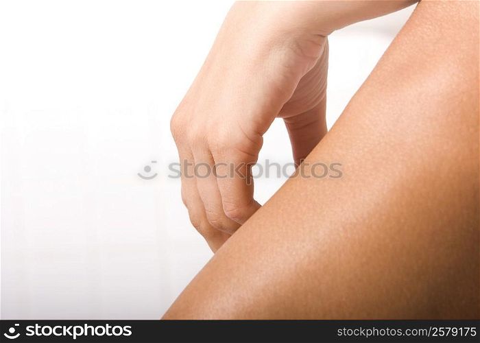 Close-up of a human hand over a human leg