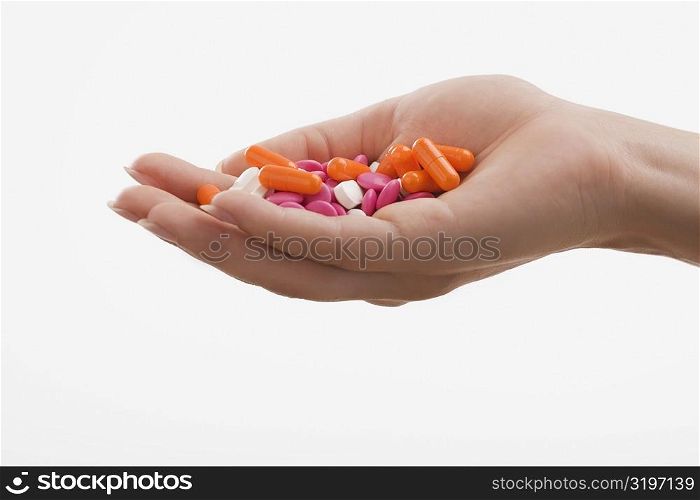Close-up of a human palm holding pills