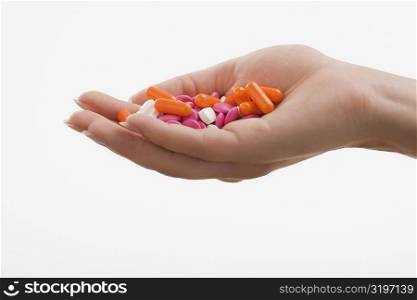 Close-up of a human palm holding pills