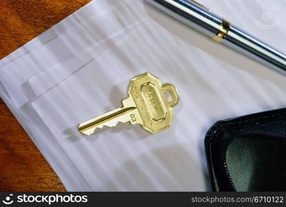 Close-up of a key on sheets of paper
