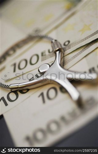 Close-up of a key ring on one hundred Euro banknotes
