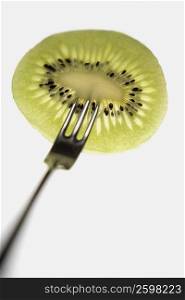 Close-up of a kiwi fruit with a fork