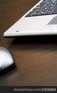 Close-up of a laptop with a computer mouse