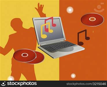 Close-up of a laptop with CD&acute;s and a person dancing in the background