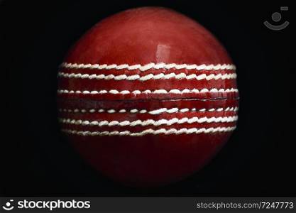 Close up of a leather cricket ball showing the seam