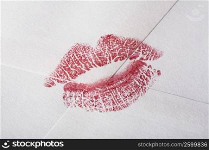 Close-up of a lipstick kiss on an envelop
