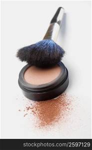 Close-up of a make-up brush and face powder