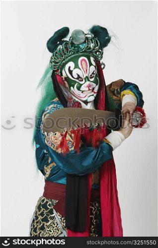 Close-up of a male Chinese opera performer holding a sword