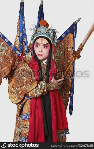 Close-up of a male Chinese opera performer holding a weapon