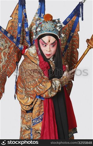 Close-up of a male Chinese opera performer holding a weapon