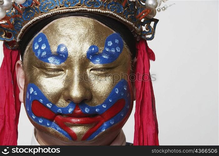 Close-up of a male Chinese opera performer with his eyes closed