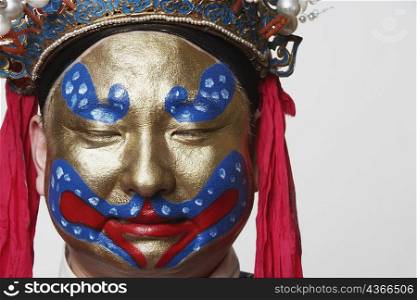 Close-up of a male Chinese opera performer with his eyes closed