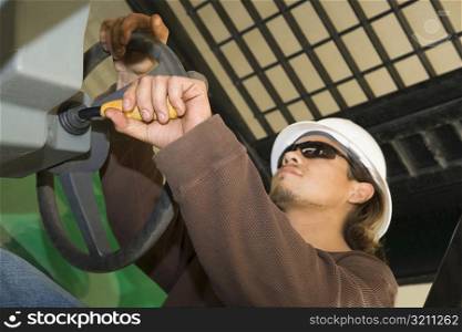 Close-up of a male construction worker holding a steering wheel