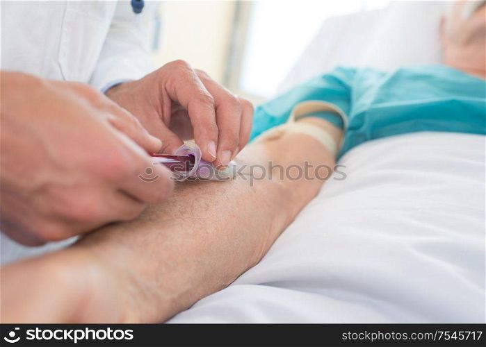 close-up of a male doctor collectng blood from patient