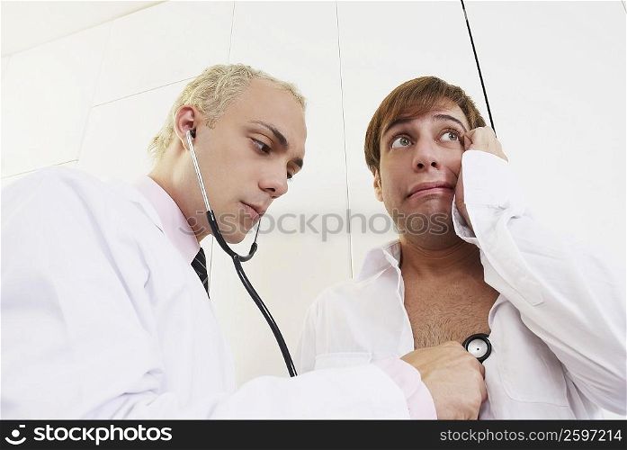 Close-up of a male doctor examining a patient with a stethoscope