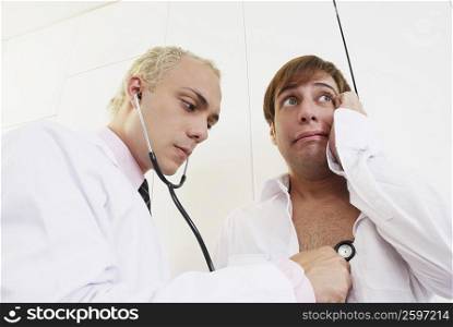 Close-up of a male doctor examining a patient with a stethoscope
