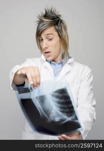 Close-up of a male doctor examining an X-Ray