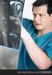 Close-up of a male doctor examining an X-Ray