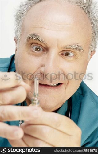Close-up of a male doctor holding a vial