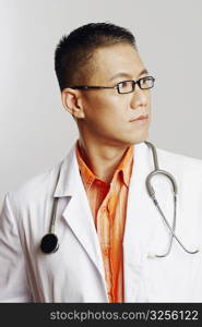 Close-up of a male doctor looking sideways and thinking