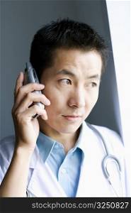 Close-up of a male doctor talking on a mobile phone