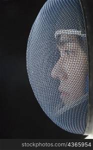 Close-up of a male fencer with a fencing mask