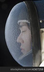Close-up of a male fencer with his eyes closed