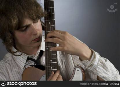 Close-up of a male guitarist playing a guitar