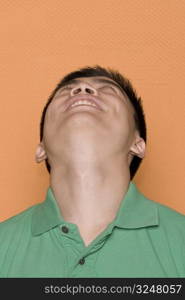 Close-up of a male office worker looking up and smiling